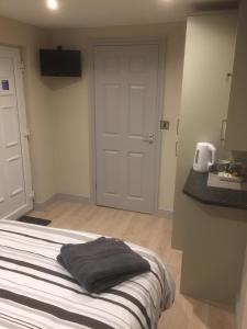 a bedroom with a bed with two pillows on it at Private en-suite guestroom Ruthin in Ruthin