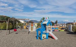 a playground with a slide and a swing set at Hotel Anna in Terracina