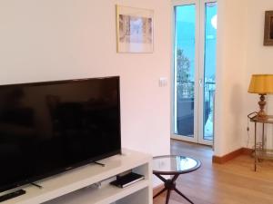 a living room with a large flat screen tv at Appartamento Monti e Relax in Saint Vincent