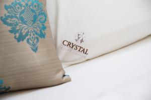 En eller flere senger på et rom på Hotel Crystal