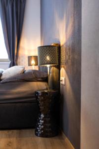 a bedroom with a bed and a lamp on the floor at alpennest stubai in Neustift im Stubaital