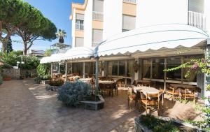 a patio with tables and chairs in front of a building at Hotel Anna in Terracina