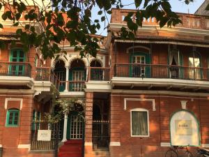 a red brick building with balconies on it at Rose Heritage Home in Varanasi