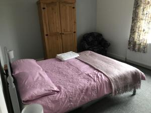 グールにあるriverside cottage east yorkshireのベッドルーム(紫の毛布付きのベッド1台付)