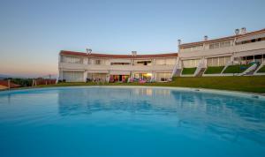 an empty swimming pool in front of a building at River-side Villa in Vila Nova de Cerveira