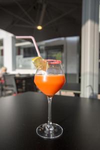 a glass of orange juice sitting on a table at Hôtel Les Frangins in Saint-Omer