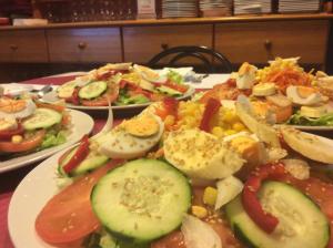 a table full of plates of food with vegetables at Hotel Sonia Chipude in El Cercado