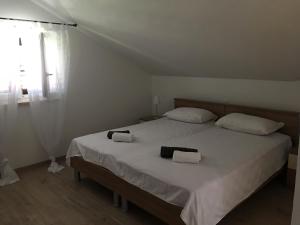 a bedroom with a large bed with two towels on it at Villa Belvedere Žiža in Donji Humac +45 photos