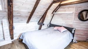 a bedroom with a bed in a wooden wall at Bergen central city apartments in Bergen