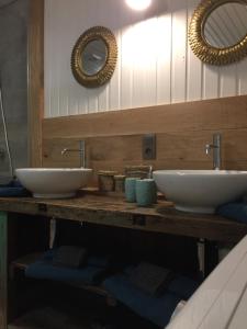 two sinks on a wooden counter in a bathroom at La Fermette du Lac in Spa +23 photos