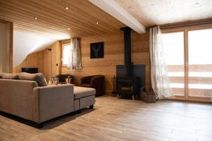 a living room with a couch and a stove at Chalet Victoire in Chamonix-Mont-Blanc