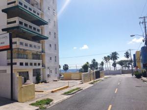 an empty street in front of a building at Caribbean Seaview apart Malecon Santo Domingo in Santo Domingo