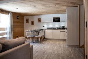 a kitchen and living room with a table and chairs at Chalet Victoire in Chamonix-Mont-Blanc