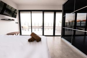 a brown teddy bear sitting on a bed in a bedroom at Villa Daniela heated pool וילה דניאלה בריכה מחוממת in Eilat