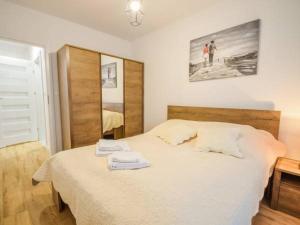 sypialnia z łóżkiem z dwoma ręcznikami w obiekcie Apartament Bliżej Morza w Kołobrzegu