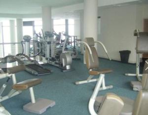 a gym with several treadmills and exercise bikes at Cosy & Stylish apartment with a priceless view in Cape Town