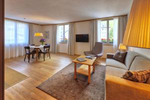 a living room with a couch and a table at Residence Zur Post Sexten in Sesto