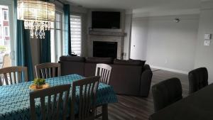 a living room with a table and a couch at Condo Lac Archambault 295 in Saint-Donat-de-Montcalm