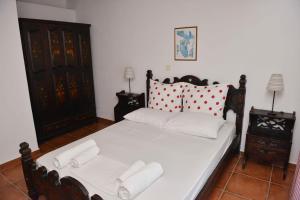 a bedroom with a bed with two white pillows at Paradisia Villas in Naxos Chora