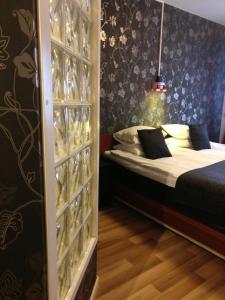 a bedroom with a bed and a glass wall at Hotell Marieberg in Kristinehamn