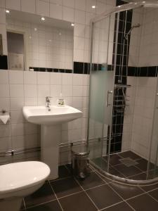a bathroom with a sink and a shower at Hotell Marieberg in Kristinehamn