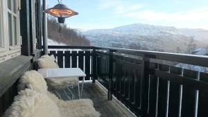 a balcony with a bench and a view of mountains at Røldal in Røldal