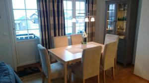 a dining room with a wooden table and chairs at Røldal in Røldal