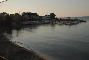 a large body of water with boats in it at Summer Beach Rooms in Fontane Bianche