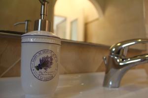 a bottle of soap sitting on a sink next to a faucet at Casa Maria in Monterosso al Mare +23 photos
