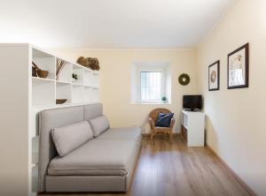 a living room with a couch and a television at Quiet and charming apartment in the centre with air conditioned in Como