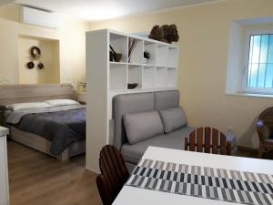 a bedroom with a bed and a couch and a table at Quiet and charming apartment in the centre with air conditioned in Como