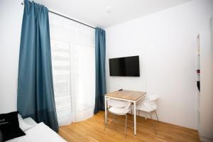 a room with a table and chairs and a window at My room serviced apartment-Messe in Munich