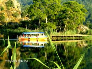 a yellow boat on the water near a bridge at Dalyan Terrace Hotel in Dalyan