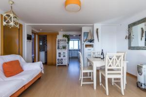 ein Wohnzimmer mit einem Sofa und einem Tisch sowie eine Küche in der Unterkunft Apartamento Calipso in El Palmar