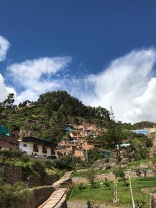 a village on a hill with houses on it at Namaste House in Cusco