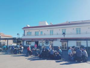 a group of people sitting outside of a building at Hotel Sonia Chipude in El Cercado