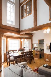 a dining room and kitchen with a table and chairs at Sapporo Luxury Log House 5Brm max 18ppl 4 free parking in Sapporo