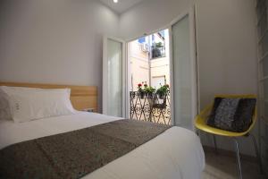 a bedroom with a large bed and a balcony at Hostal Palacio Luna in Madrid