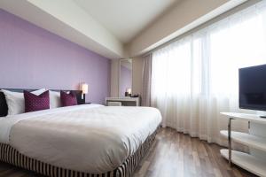 Postel nebo postele na pokoji v ubytování Sakura Terrace
