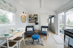 a kitchen and living room with a table and chairs at Blackbird Cottage in Lincoln