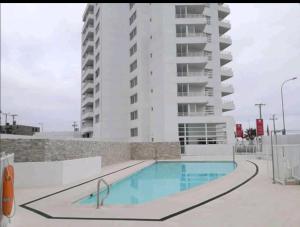 una piscina frente a un edificio de apartamentos en Departamento avenida del mar, en La Serena