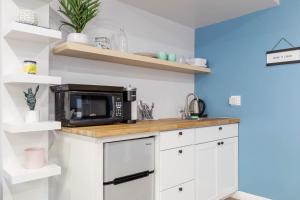 a kitchen with a microwave on top of a counter at Spacious Guest Studio with Private Entry in Los Angeles