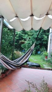 a hammock hanging from a tent in a garden at 樹之間民宿 樟間 櫸間 in Dongshi