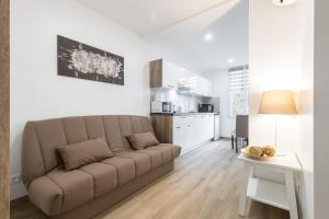 a living room with a couch and a kitchen at Sleep in Antibes City Port in Antibes
