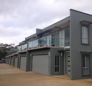 a building with a row of garages at Griffith Prestige Apartments in Griffith