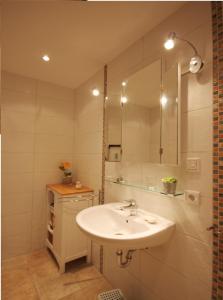 a bathroom with a sink and a mirror at Ferienwohnung Baltic Sea in Börgerende-Rethwisch