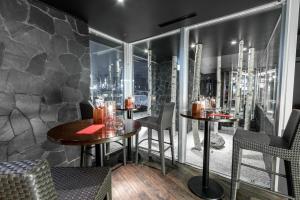 a restaurant with two tables and chairs and a window at The Vale Niseko in Kutchan