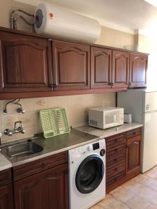 a kitchen with a washing machine and a sink at Apartment Sea View 20m to beach - TOP Quarteira ALGARVE in Quarteira