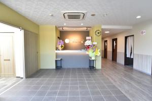 a lobby of a hospital with flowers on a counter at Alaise De Bale Shirahama in Shirahama +82 photos