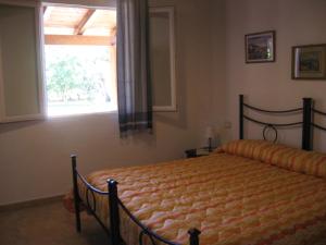 a bedroom with a bed in front of a window at Agriturismo La Barca In Secca in Olmedo